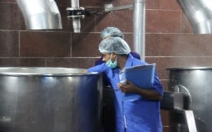 Kitchen employee checking the temperature